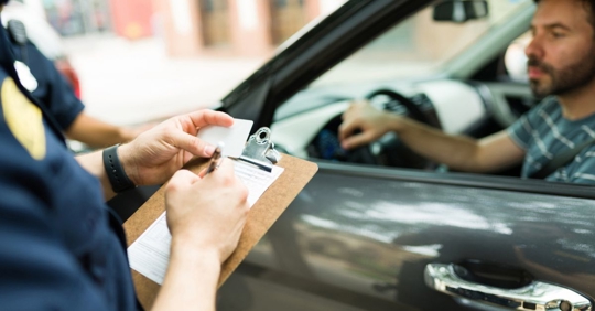 police writing a traffic ticket