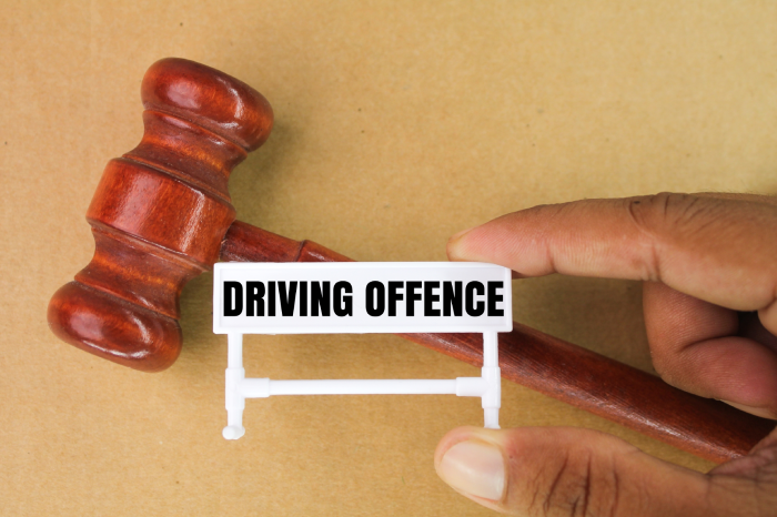 judge's gavel and a small sign with the word driving offence. concept of traffic law