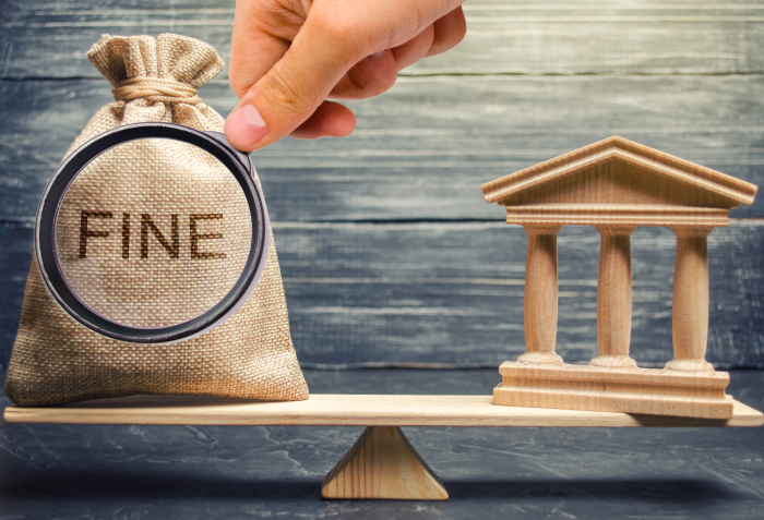 Money bag with the word Fine and the courthouse or bank on the scales of justice. The concept of paying a penalty. Financial punishment. Violations of traffic laws.
