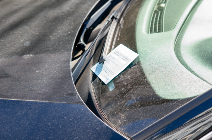 Speeding ticket on a windshield for illegal parking in the city