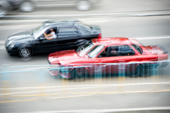 Cars at speed. Street racing. Blurred cars at speed.