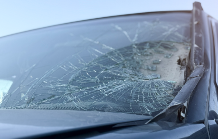 Car accident crash shuttered cracked broken damaged windshield at driver side. Dangerous, careless, unsafe, drunk, impaired driving,