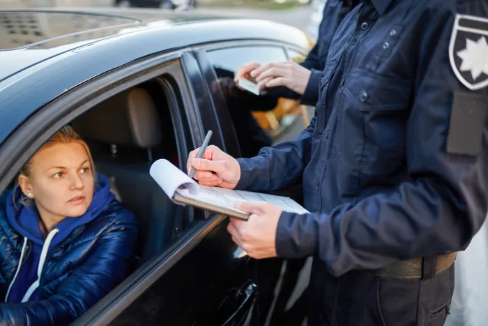 Police patrol checking driver's license of driver