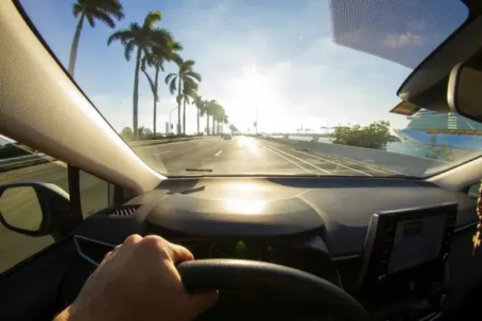 An image of a car driving in the middle of the road